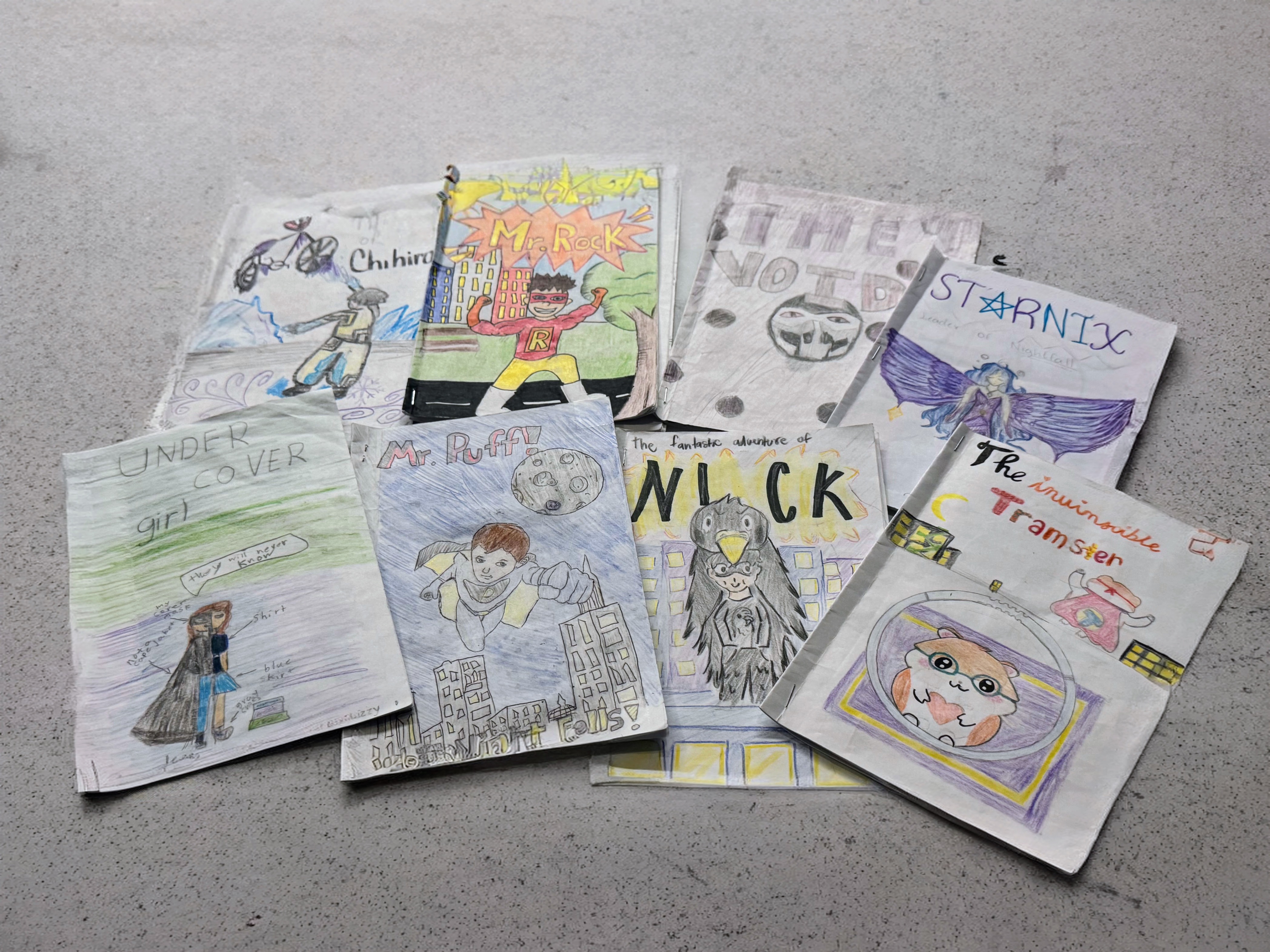 Several authentic student-created paper comic book covers