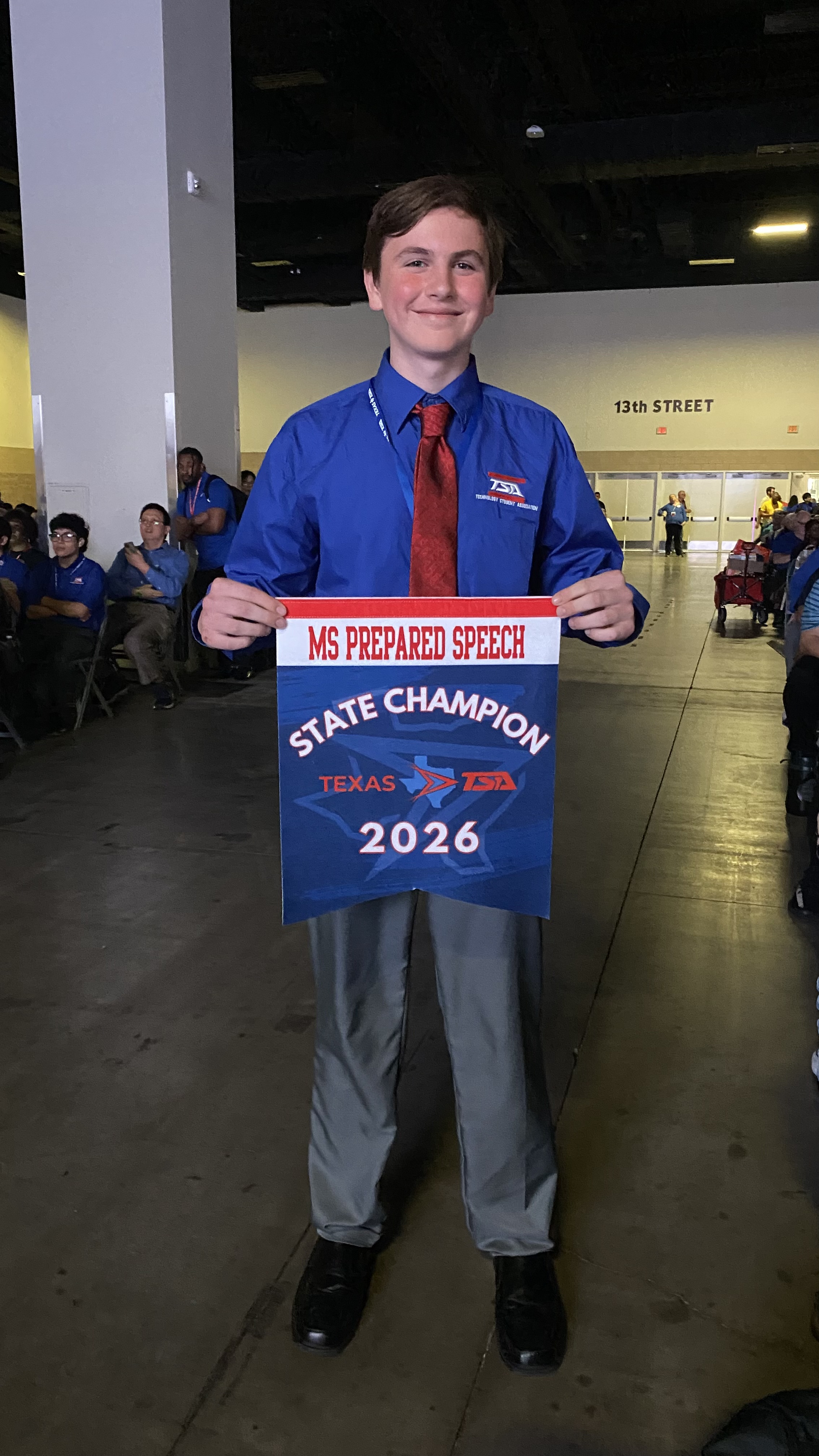 A Bowie student with his Prepared Speech state championship banner.